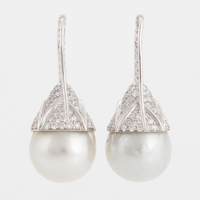 A pair of cultured South sea perl and diamond earrings.