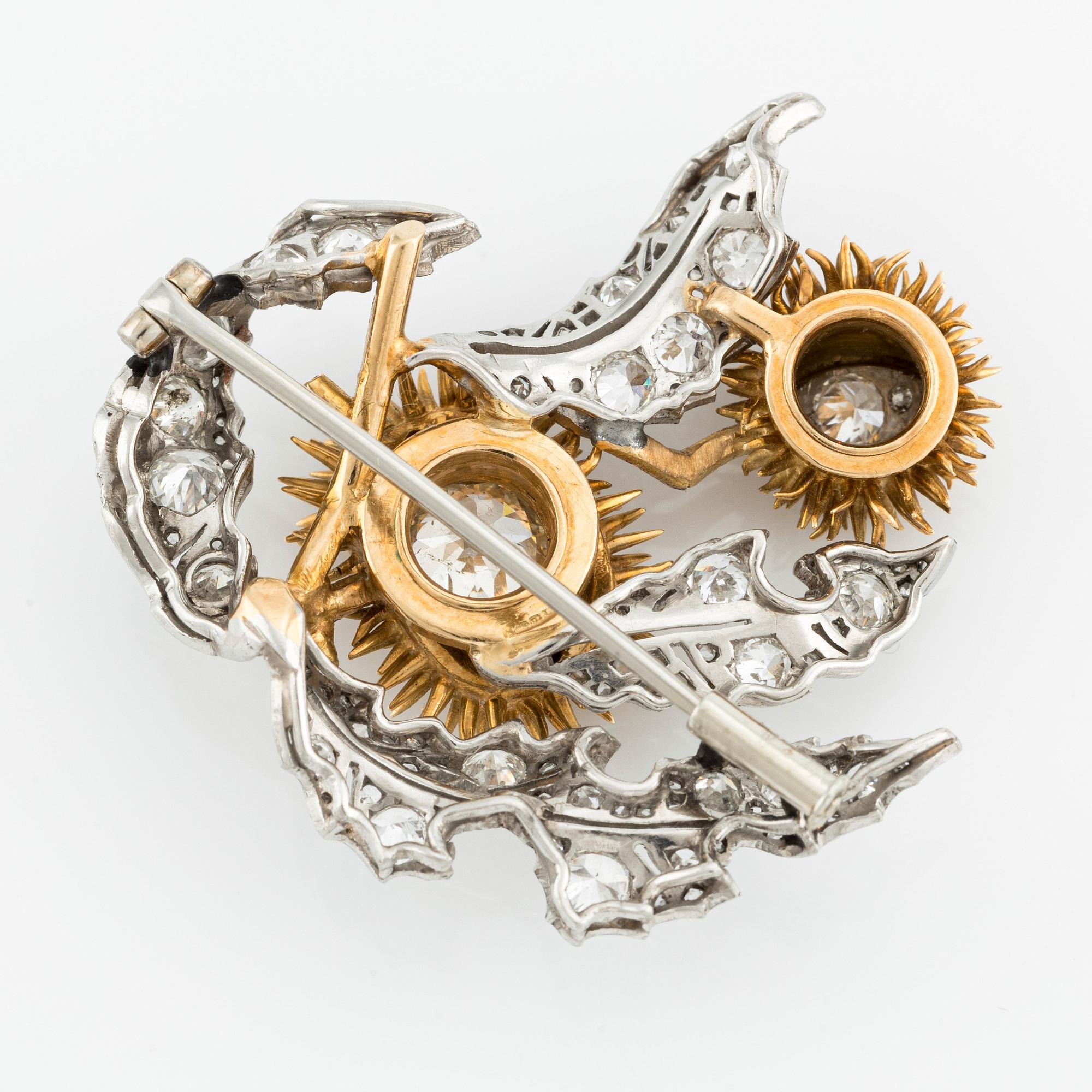 A platinum and 18K gold brooch with an old-cut diamond approximately 1.50 cts.