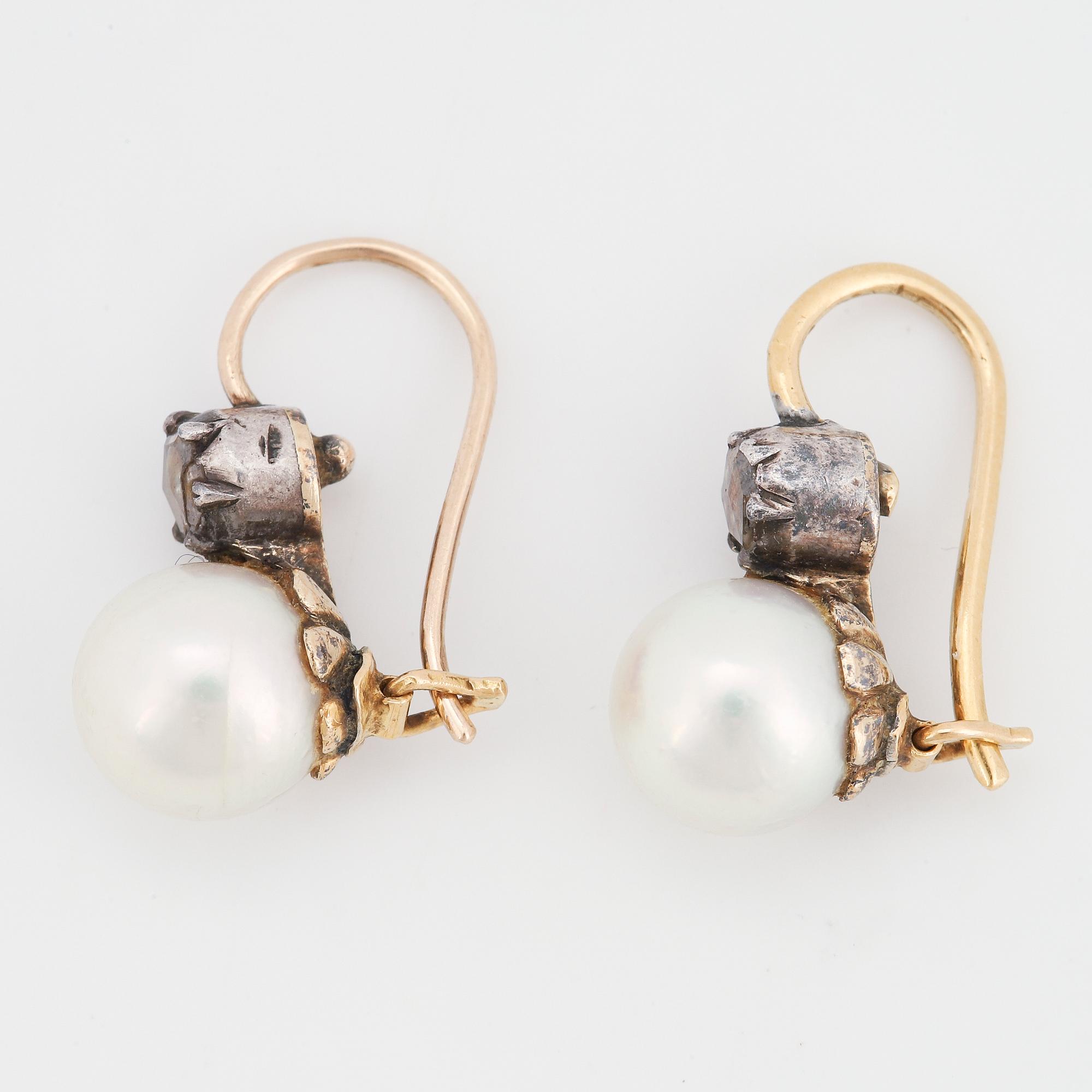 A pair of pearl and rose-cut diamond earrings.