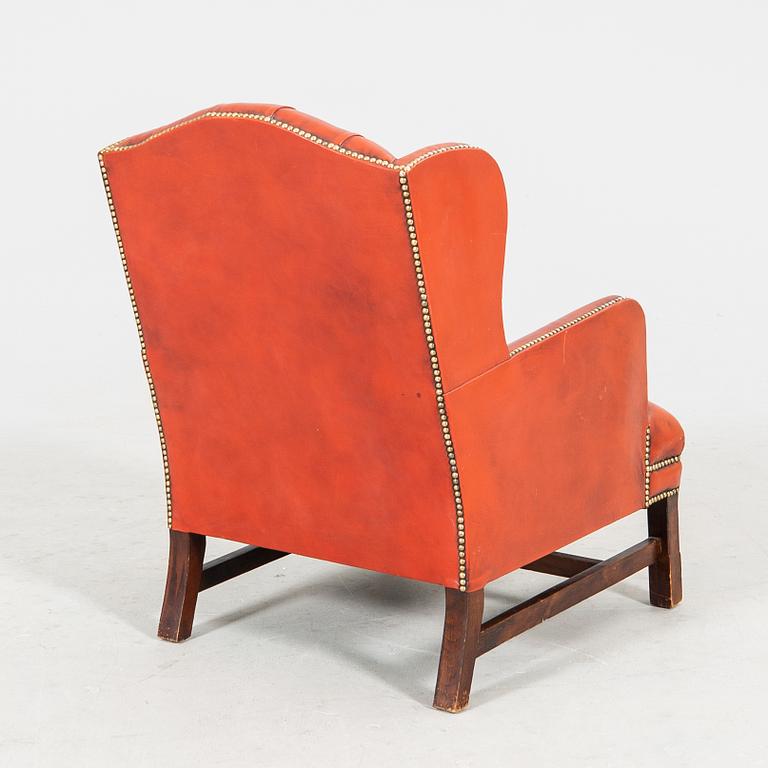 A late 20th century wingback leather chair.