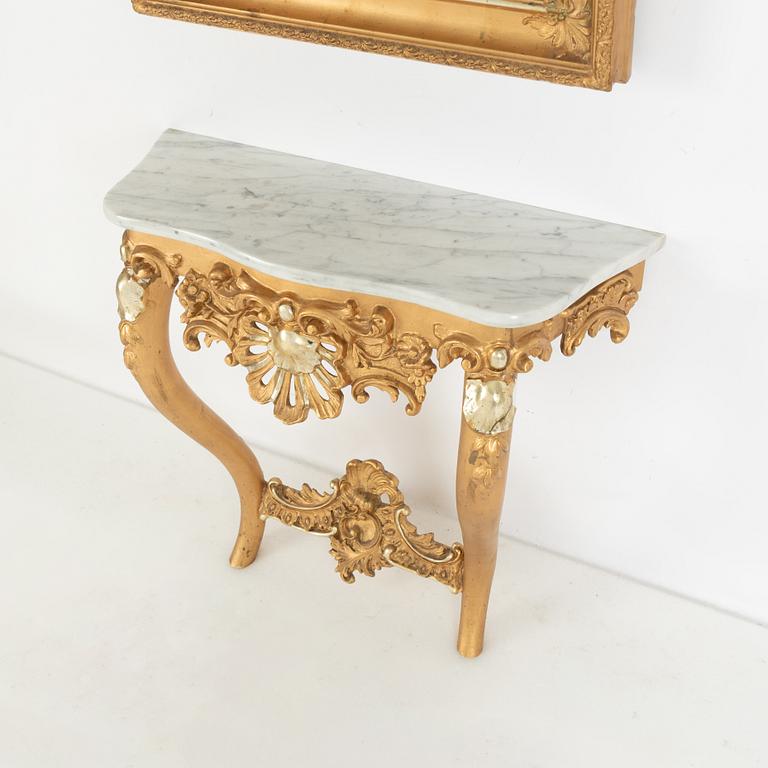 A rococo-style mirror and console table, around 1900.