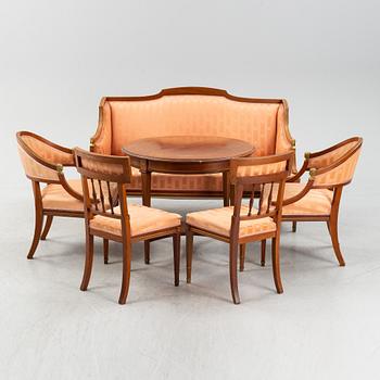An Empire style table, a sofa and eight chairs, early 20th Century.