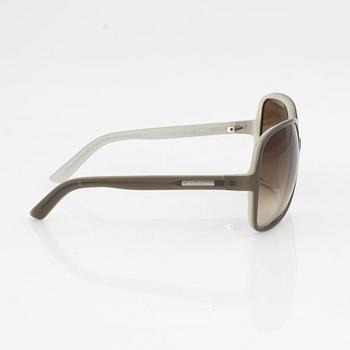 Yves Saint Laurent, a pair of grey plastic sunglasses.