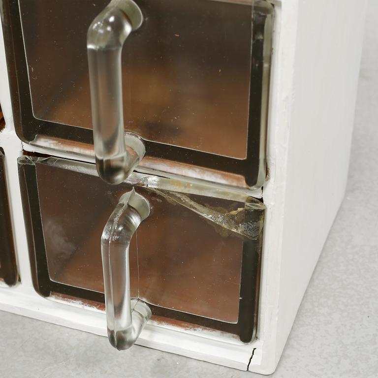 A spice rack from around the middle of the 20th century.