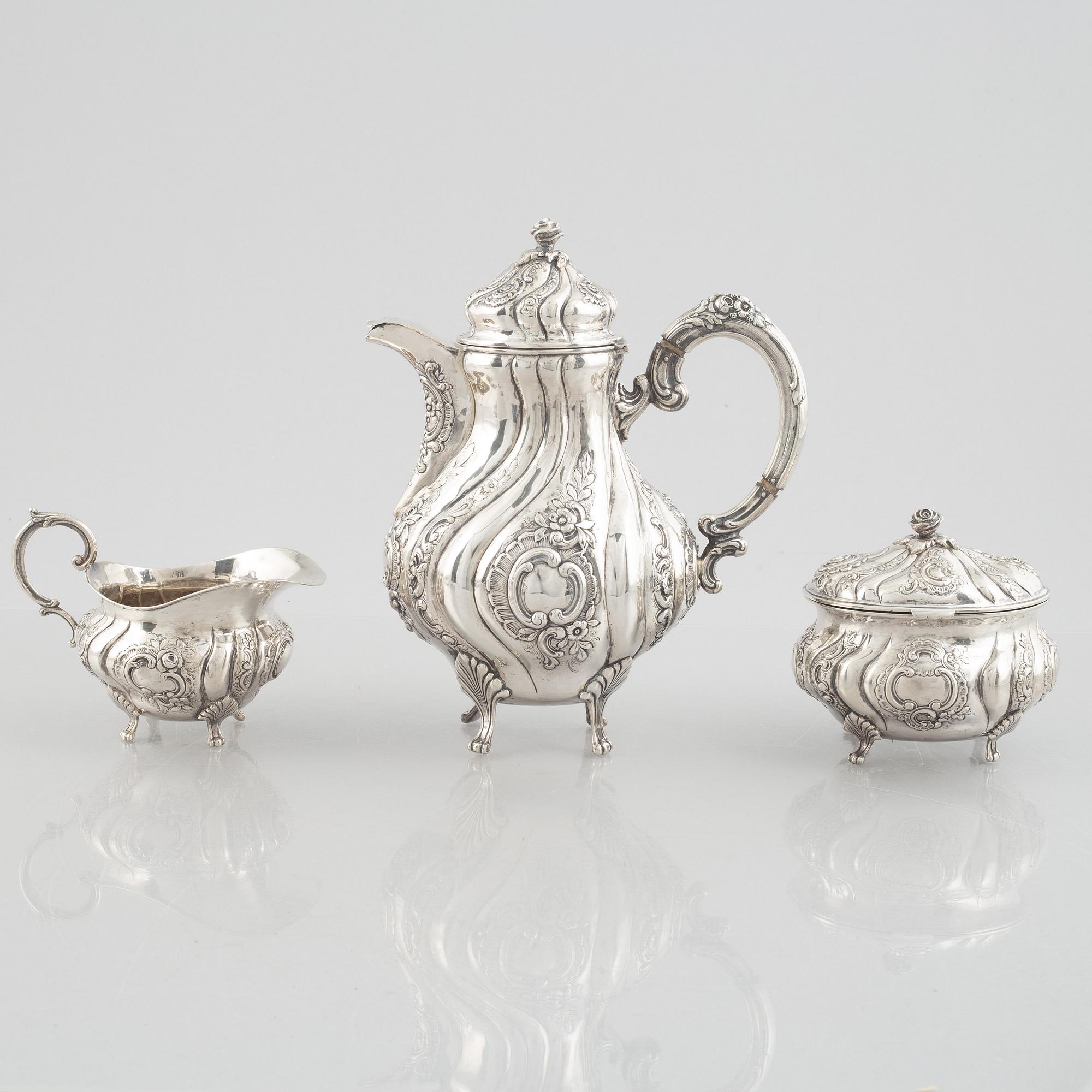 A Rococo-style silver coffee pot, creamer and sugar bowl, 20th Century.