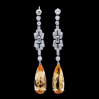 27. A brilliant- and baguette cut diamond and yellow topaz earrings, Art Deco, later topaz.