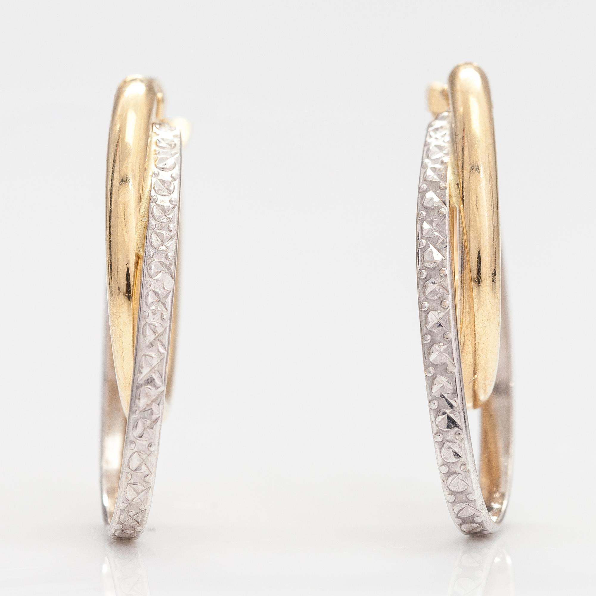 A pair of 14K gold earrings.
