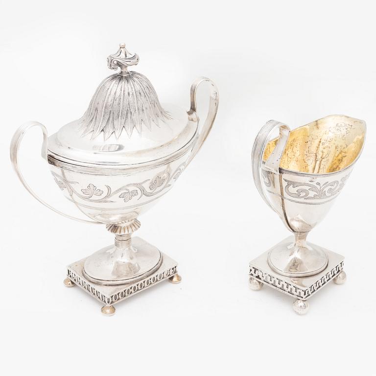 A silver sugarbowl with lid and a creamer, marks of Olof Hellbom, Stockholm, Sweden 1799-1800.