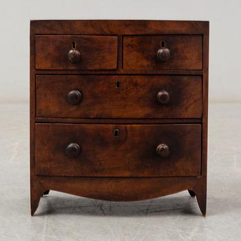 An early 19th Century Regency miniature chest of drawers.