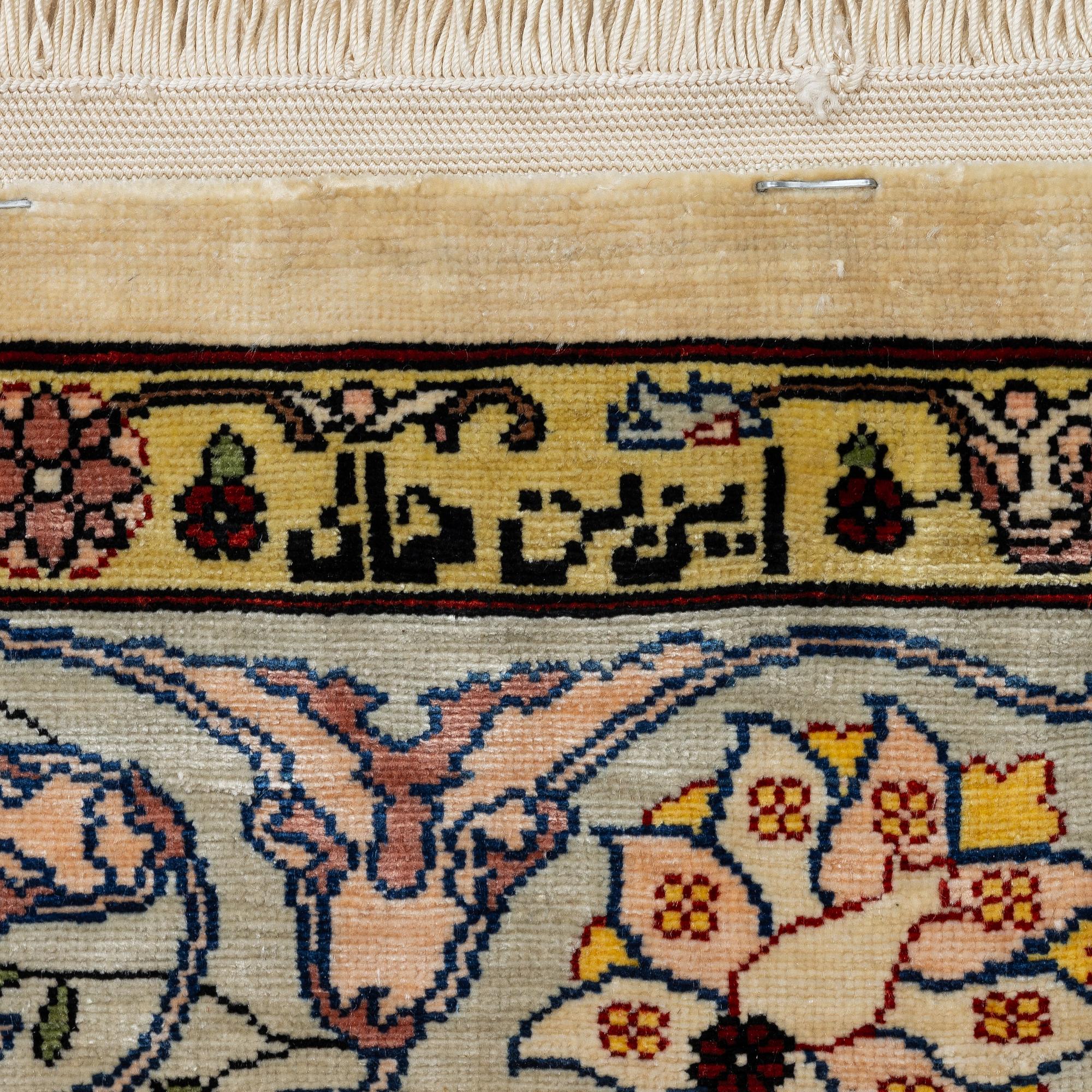 A silk Hereke rug, Turkey, approx. 82 x 58 cm.