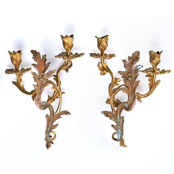 A pair of Rococo 18th century gilt bronze two light wall-lights.