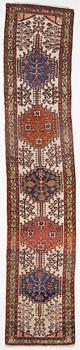 An oriental runner, c. 395 x 82 cm.