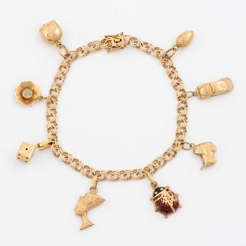 Bracelet, 18K gold bismarck link. With charms.