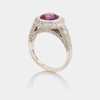 973. An 18K white gold Max Prus ring set with a faceted pink sapphire and round brilliant-cut diamonds.