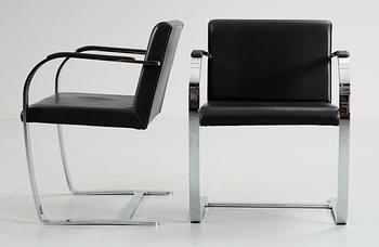 A pair of Ludwig Mies van der Rohe 'Brno' black leather and steel armchairs, Knoll International, USA.