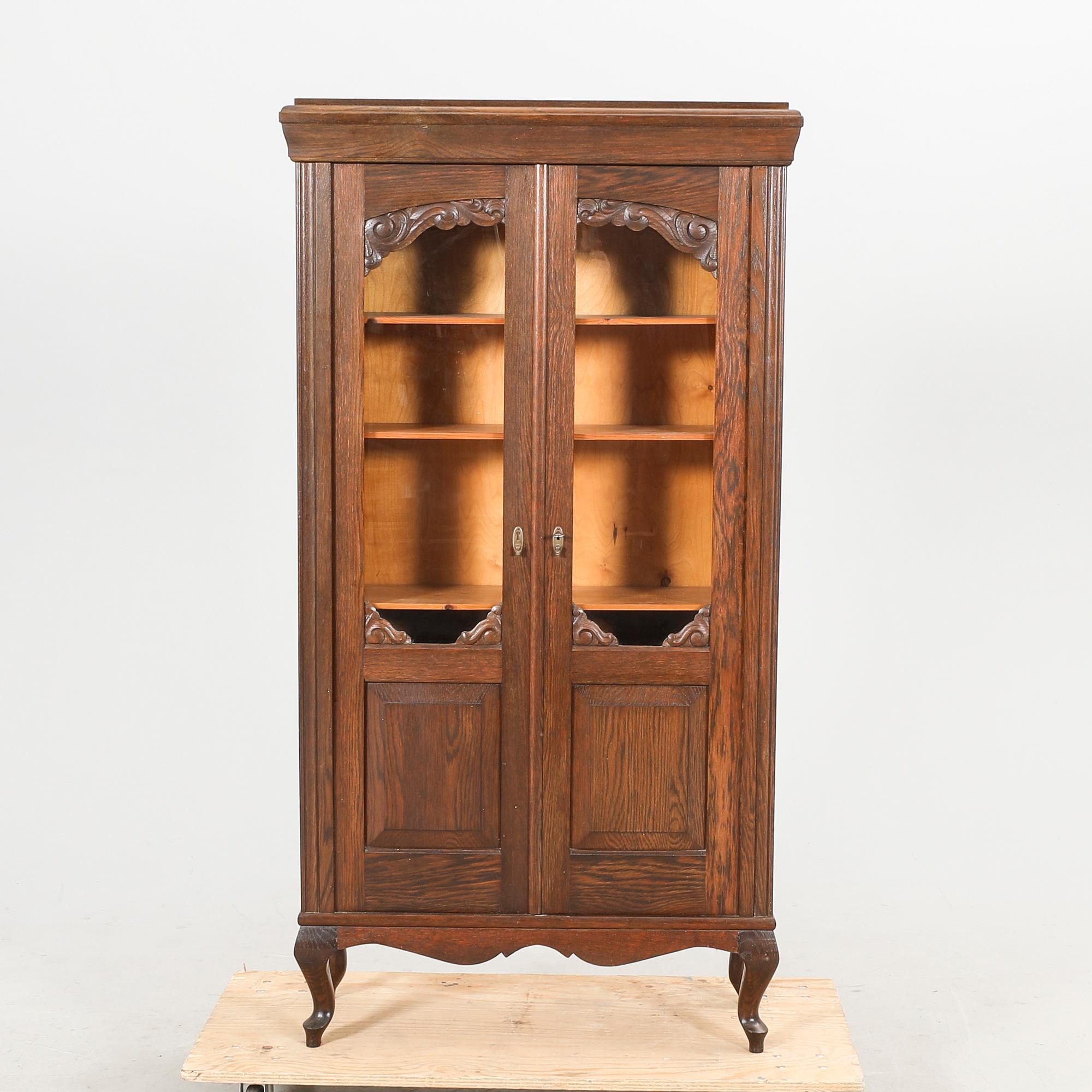 A 1920s oak display cabinet.
