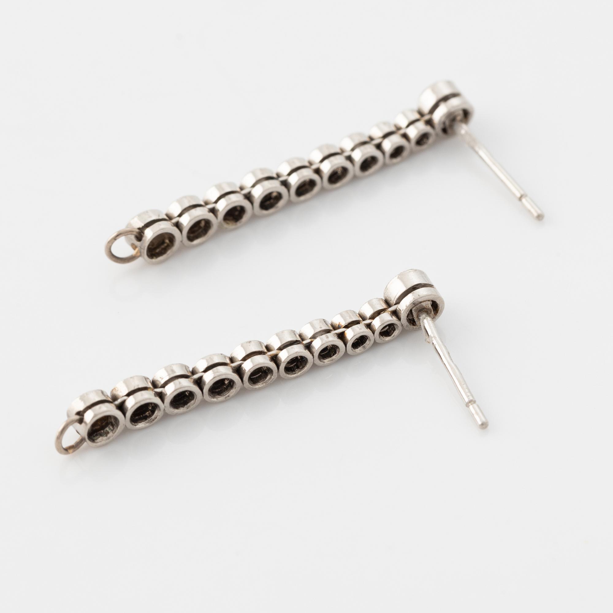 Platinum and brilliant cut diamond line earrings.