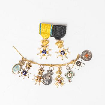 Miniature orders and medals on chain and buckle.