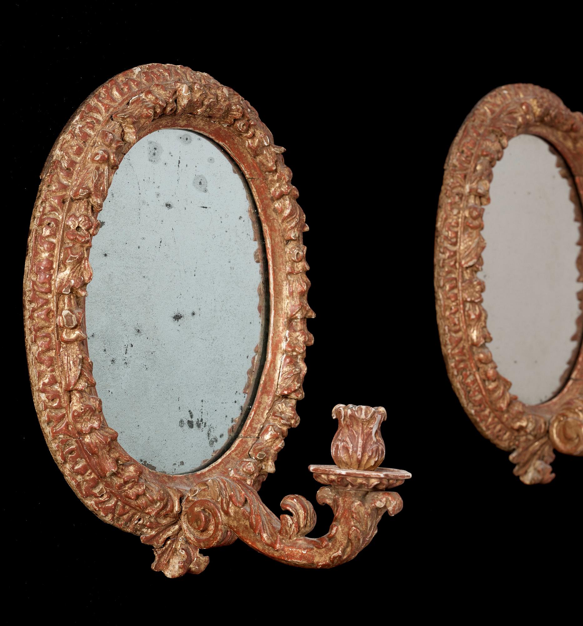A pair of Swedish Baroque circa 1700 one-light girandole mirrors.