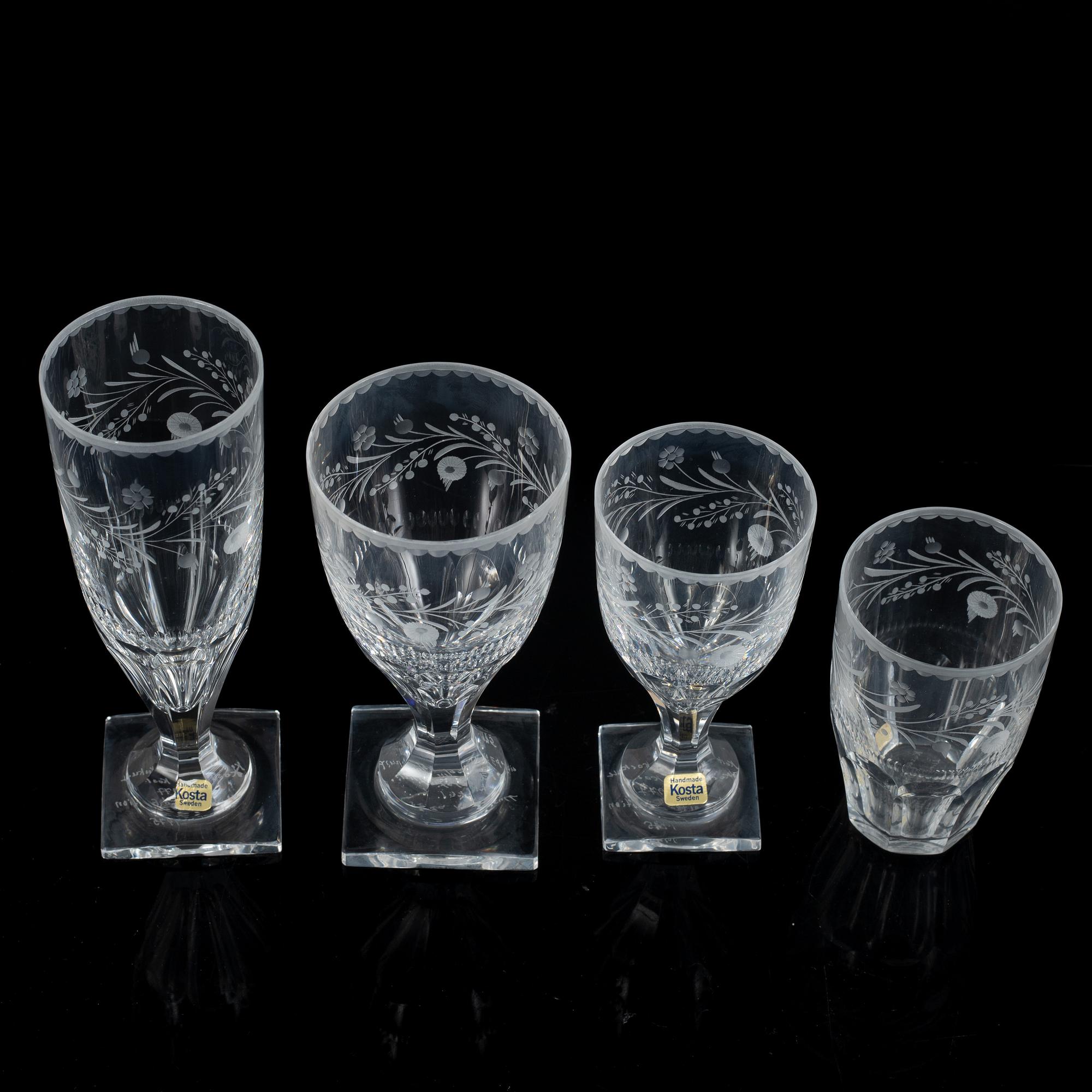 A display cabinet with a 47-piece glass service, "Koskull" from Kosta, Sweden.