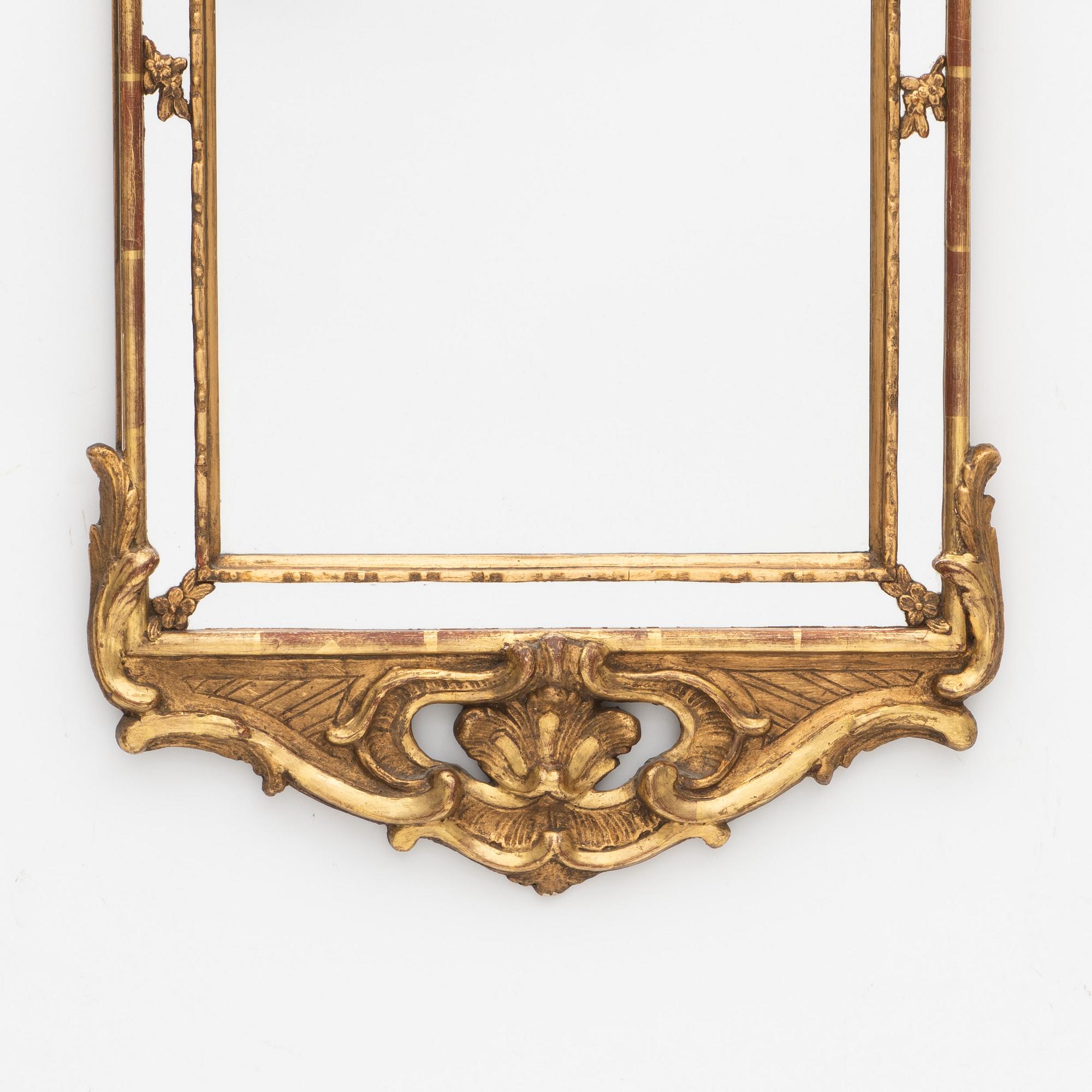 A Rococo style mirror, circa 1900.