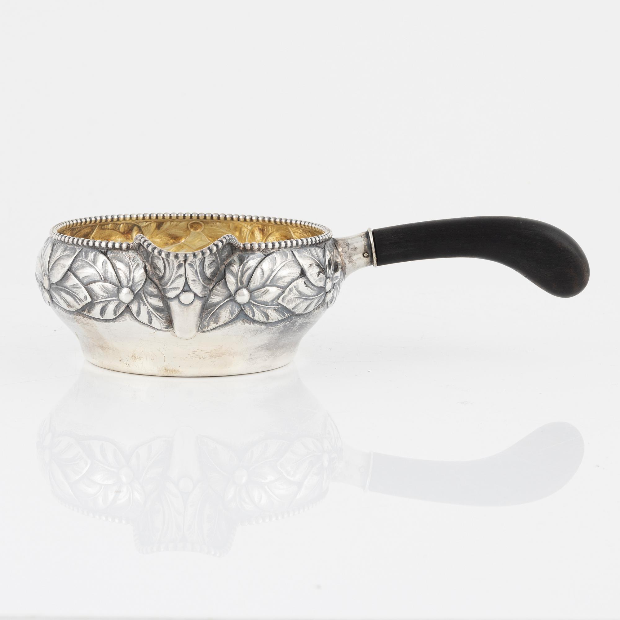 A parcel.gilt sauce dish with handle, Denmark, 1919.