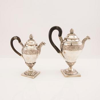 A three pcs Empire silver tea service unknown hallmarks, toal weight 1133 grams.