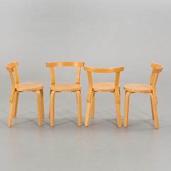 A TABLE AND FOUR CHAIRS DESIGNED BY ALVAR AALTO FOR ARTEK.