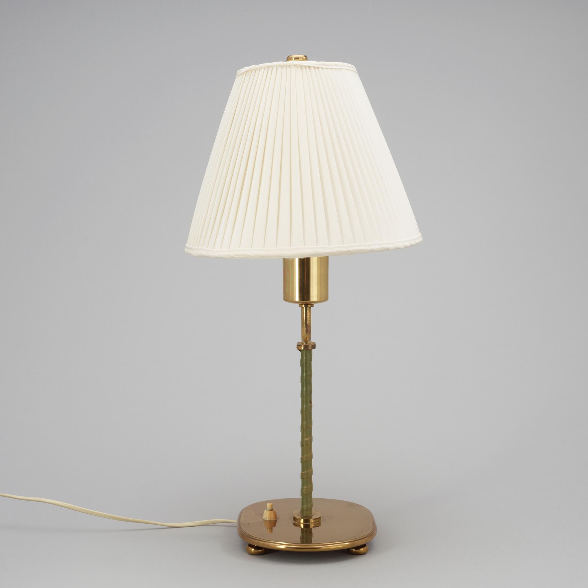 A Josef Frank brass and green leather table lamp by Svenskt Tenn.