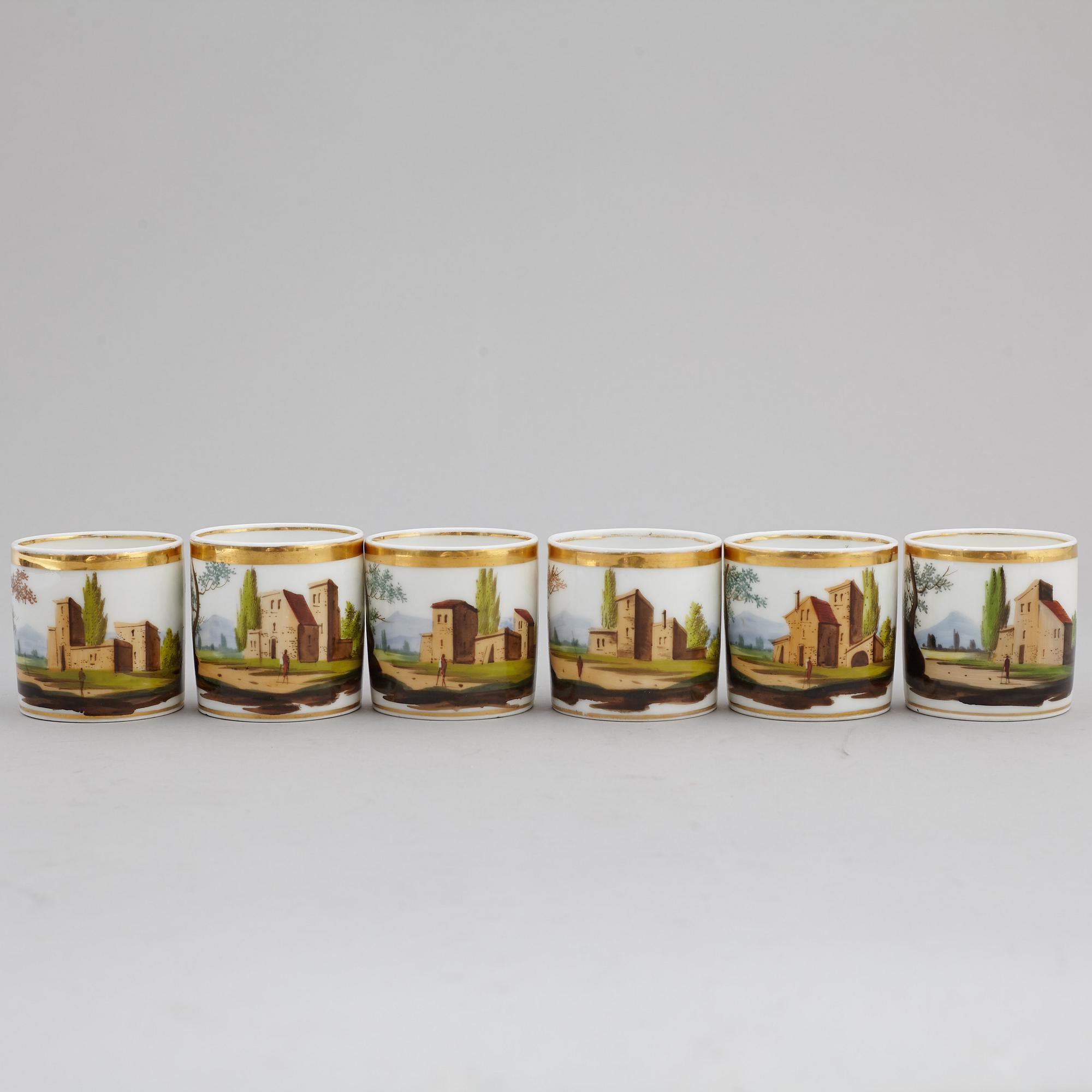 A group of seven cups, one with dish, Germany and France, 19th century.