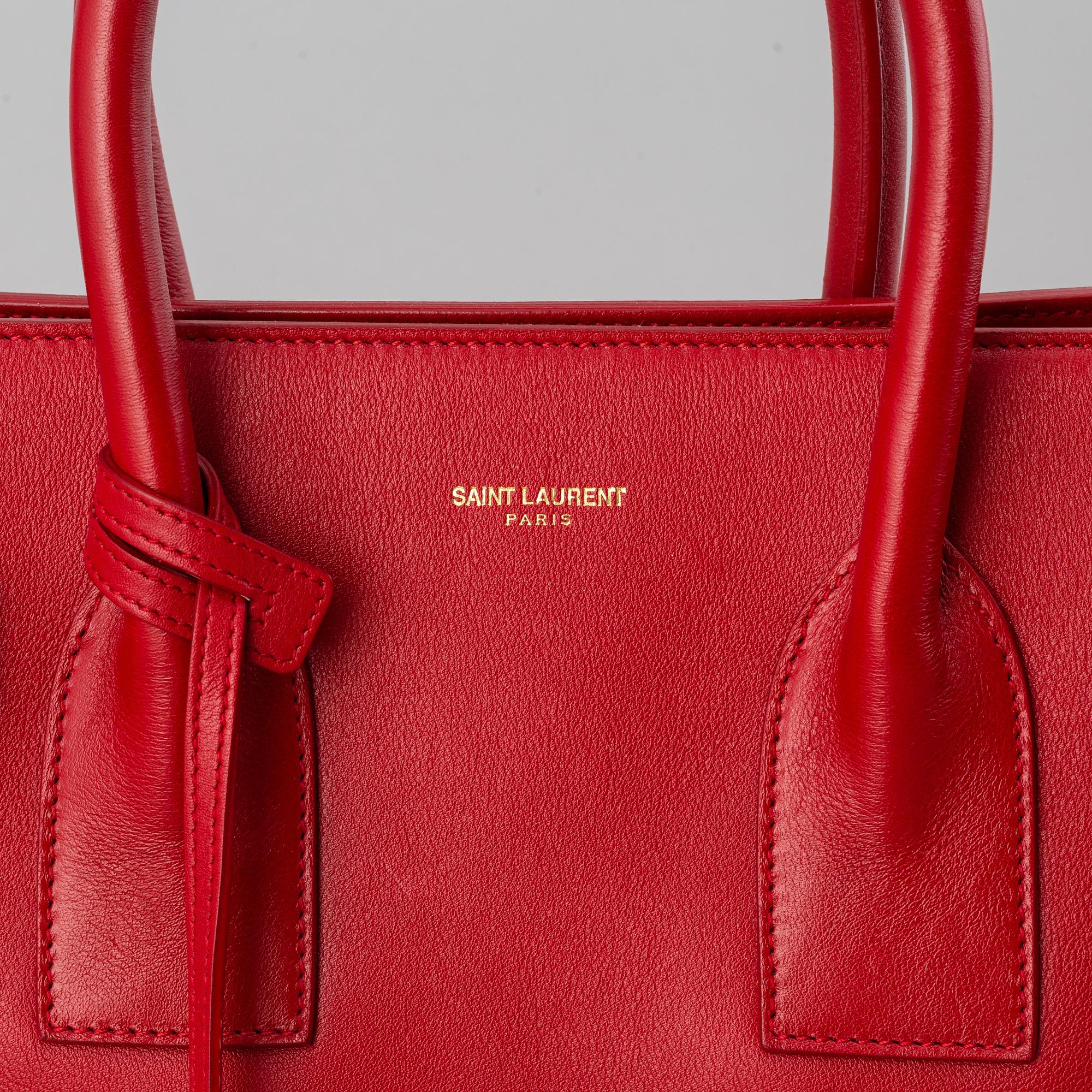 Saint Laurent, a red leather 'Sac du Jour Small' bag.