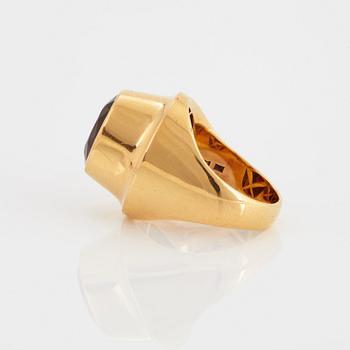 A Sigurd Persson 18K gold ring set with a faceted garnet.