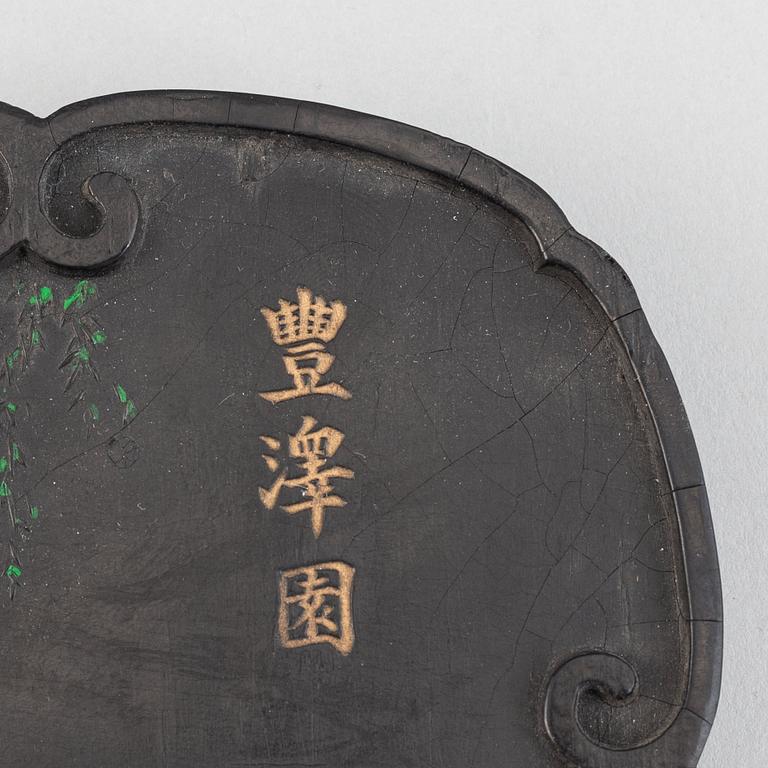 A Chinese ink-cake, with calligraphy and decorated with an ox, 20th Century.