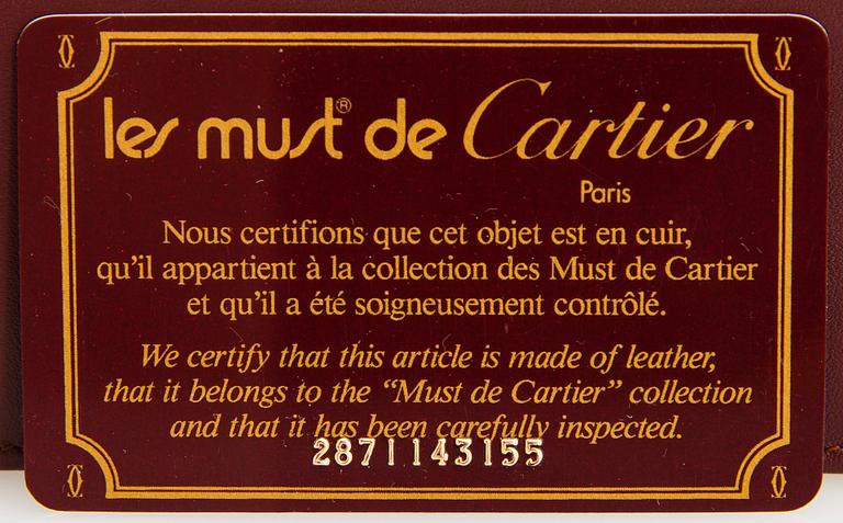 Cartier, must de Cartier leather clutch.