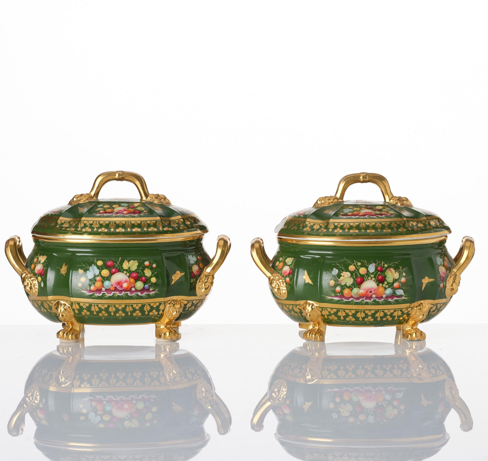 A pair of armorial butter tureens with covers and stands and two fruit dishes, Derby, England, circa 1830.