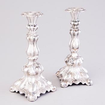 A pair of rococo style candlesticks in silver. Kultakeskus Oy, Hämeenlinna, Finland 1946.