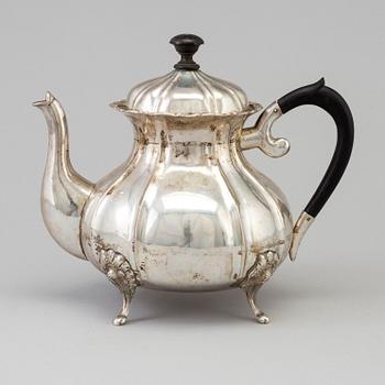 A silver rococo style teapot.