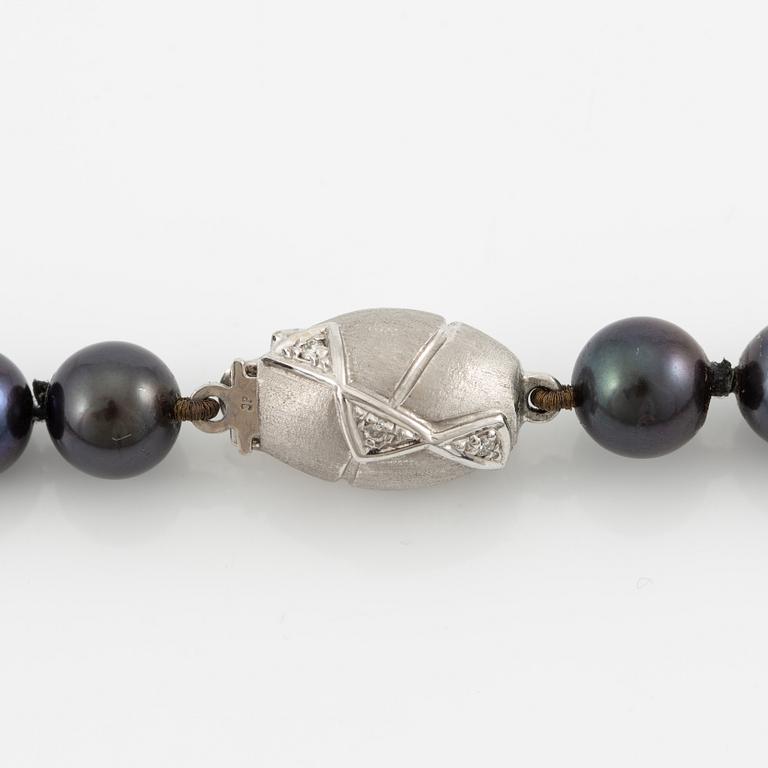 Necklace of cultured freshwater pearls, clasped with 14K white gold and round brilliant-cut diamonds.