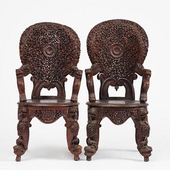 A pair of carved 'blackwood' armchairs, Bombay presidency, British Raj, circa 1880.