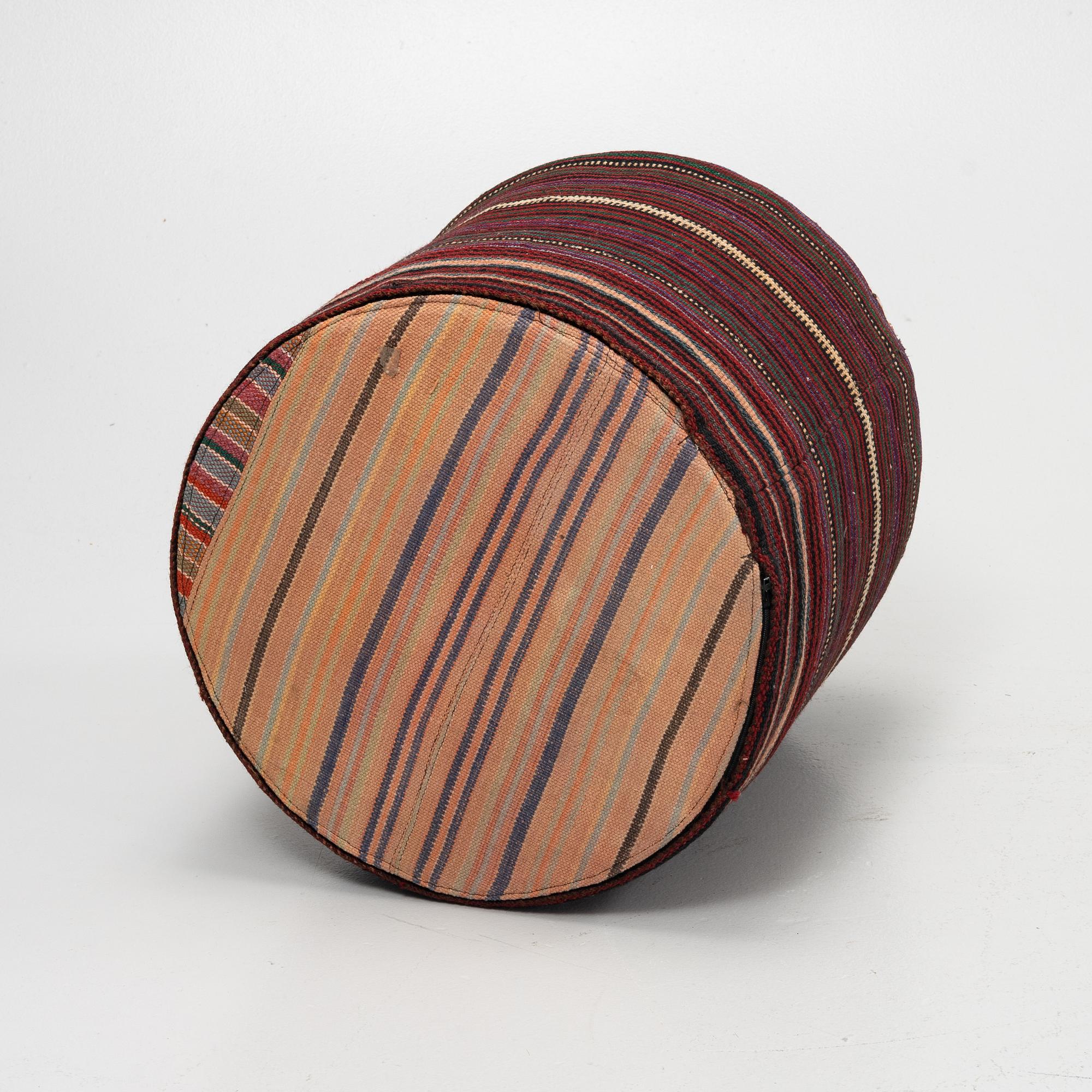 A Kelim covered stool.