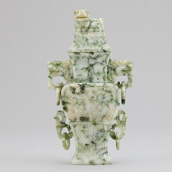 A carved green stone vase with cover, China, 20th Century.