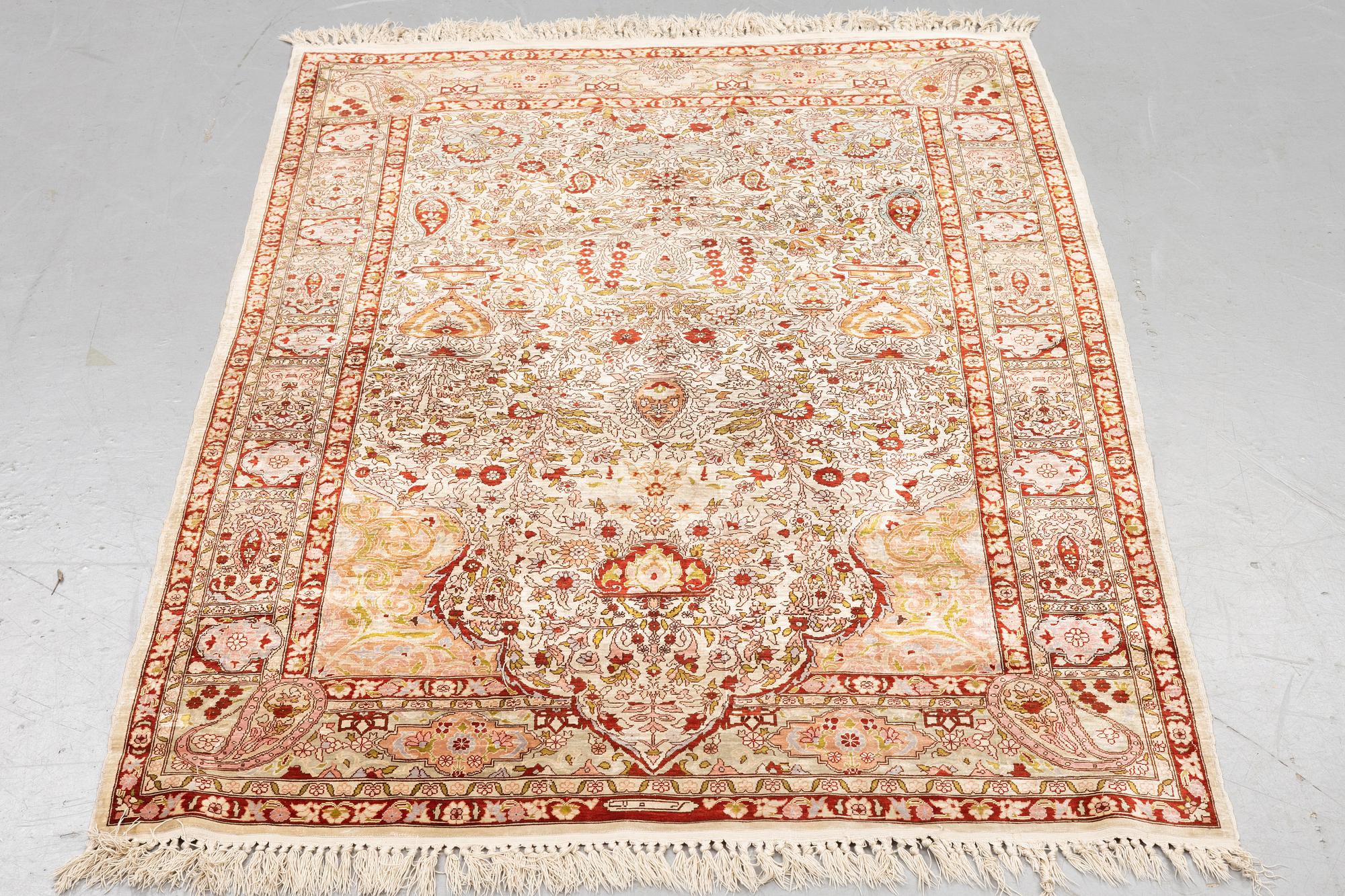 A rug, Old silk Hereke, ca 152 x 110 cm.