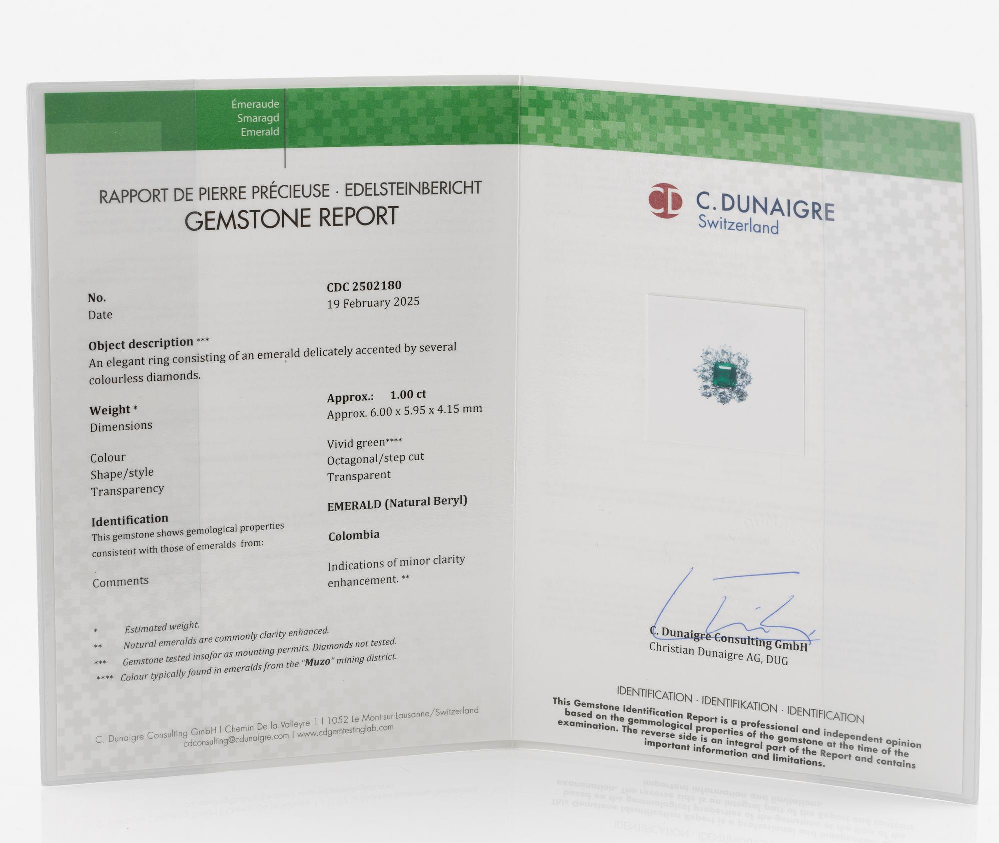 An 18K whitegold ring set with a step-cut emerald and round brilliant-cut diamonds.