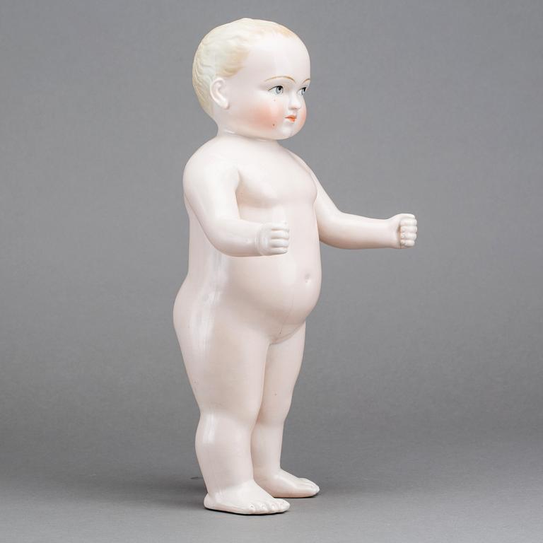 A PORCELAIN "FROZEN CHARLIE" DOLL, from around 1900.