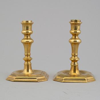 A pair of 18/19th century brass candlesticks.