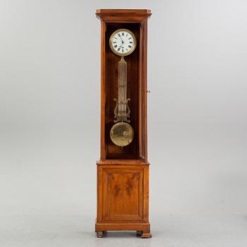 A walnut long case clock, from around the year 1900.
