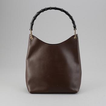 Gucci, a leather bag.