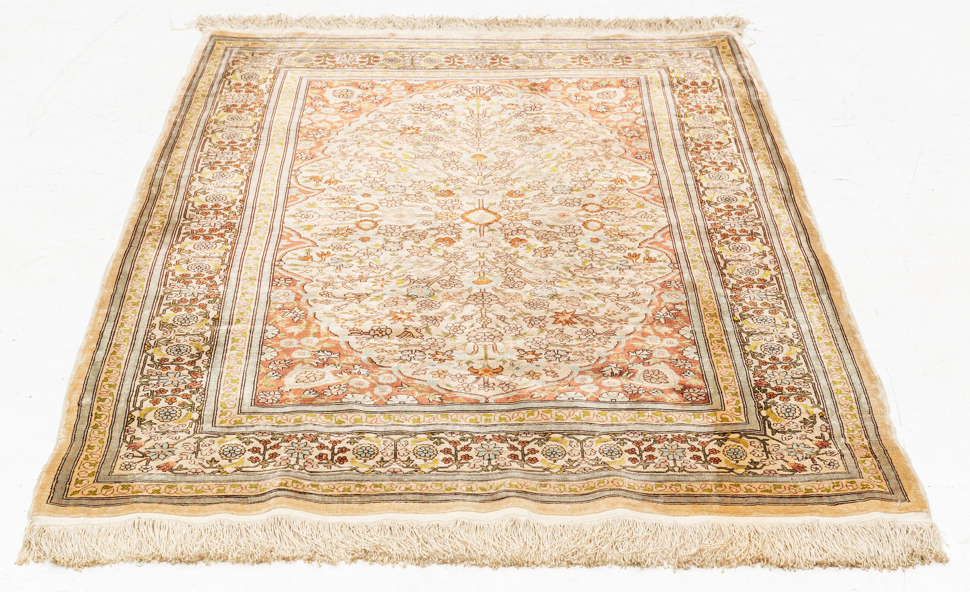 A silk Hereke rug, circa 104 x 70 cm.