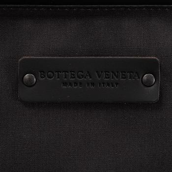 Bottega Veneta, an intrecciato leather suitcase.