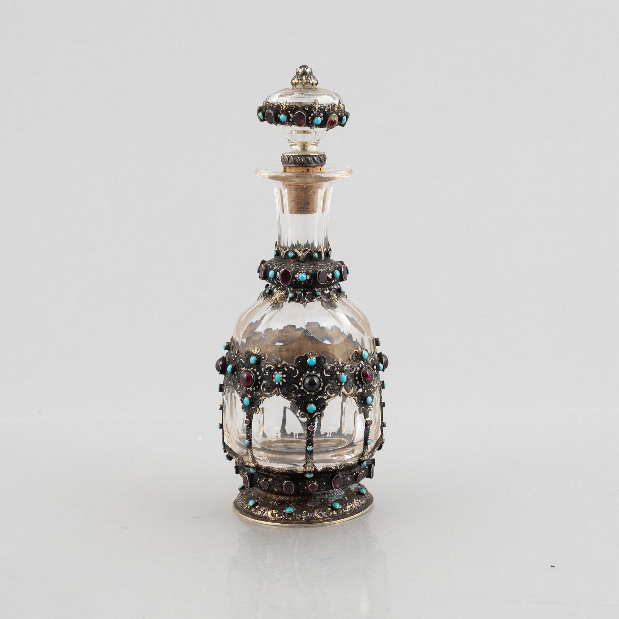 Flask with stopper, glass with mounts of partially gilded silver, late 19th century.